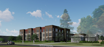 St. Louis Park apartment for rent - A modern building with a mix of brick and dark panels is surrounded by greenery and a clear sky.