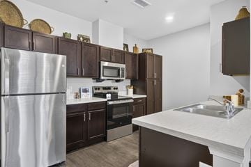 Traverse City apartment for rent - A kitchen with brown cabinets and a white refrigerator.