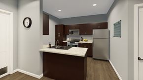 Traverse City apartment for rent - A kitchen with brown cabinets and a white countertop.