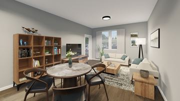 Traverse City apartment for rent - A living room with a round table and chairs, a bookshelf, and a couch.