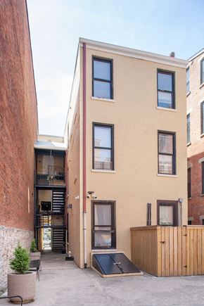 Cincinnati apartment for rent - A tan building with black windows and a black door