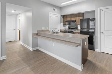 Columbus apartment for rent - a kitchen with a large center island and a black refrigerator