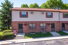 Marion apartment for rent - A red brick building with a red roof and a green lawn in front.
