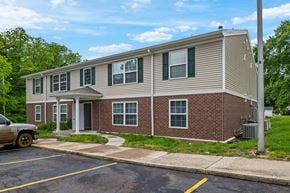 Springfield apartment for rent - A two-story building with a parking lot in front.