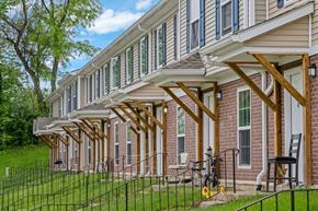 Springfield apartment for rent - A house with a porch and a bicycle on the lawn.