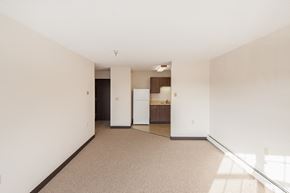 Urbana apartment for rent - A spacious room with a kitchen area in the background.