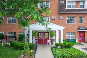 Urbana apartment for rent - A red door is on the right side of a white porch.
