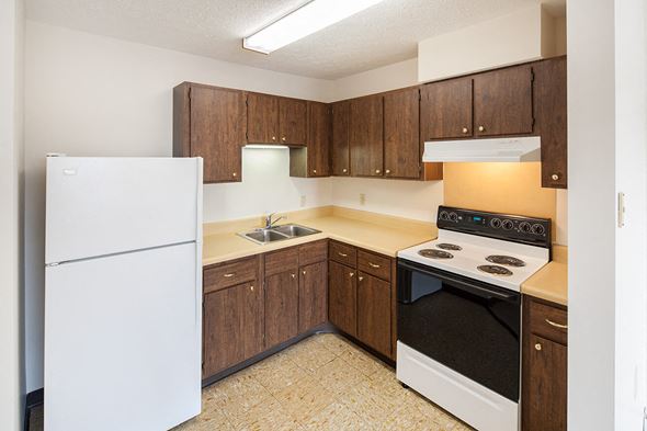 Urbana apartment for rent - A small kitchen with a white refrigerator and a white stove.