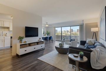 Las Vegas apartment for rent - A modern living room with a flat screen TV and a view of the city.