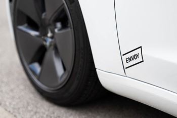 The wheel of a white car with a punctured tire