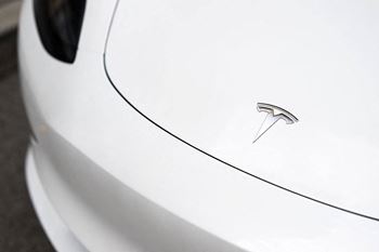 The badge on the side of a white car