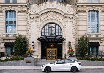 A white car parked in front of a building