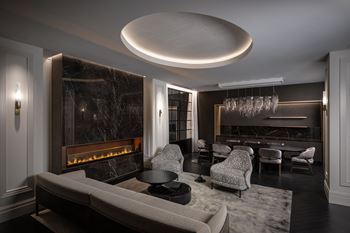 A living room with a couch and chairs and a fireplace