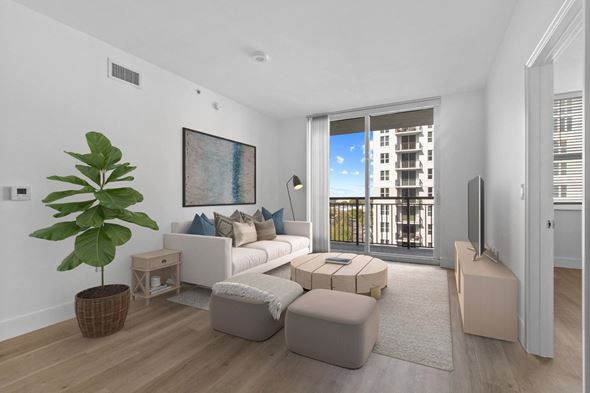 Plantation apartment for rent - a living room with a white couch and a large plant at One Plantation in Plantation, FL