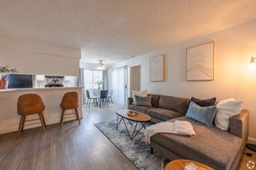 Henderson apartment for rent - A living room with a grey couch and a brown chair.