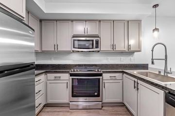 Kirkland apartment for rent - A modern kitchen with a stainless steel refrigerator and a microwave above the stove.