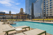 Minneapolis apartment for rent - A pool surrounded by benches and a city skyline in the background.