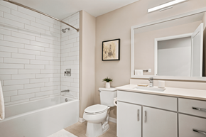 Minneapolis apartment for rent - A white bathroom with a toilet, sink, and bathtub.