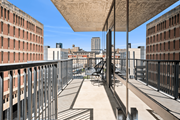 Minneapolis apartment for rent - A balcony with a table and chairs overlooks a cityscape.