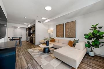 Los Angeles apartment for rent - A modern living room with a white sofa and a wooden floor.