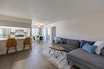 Henderson apartment for rent - A living room with a grey couch and a coffee table.