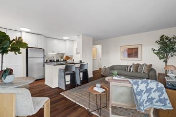Seattle apartment for rent - A modern living room with a grey couch and a wooden coffee table.