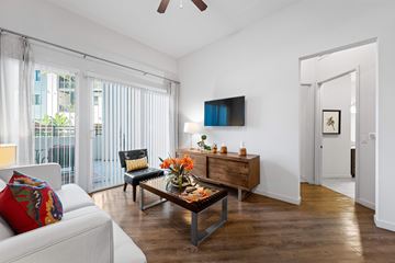 Woodland Hills apartment for rent - A living room with a white couch and a wooden coffee table.