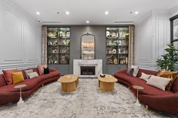 Chicago apartment for rent - A living room with a red couch and a fireplace.