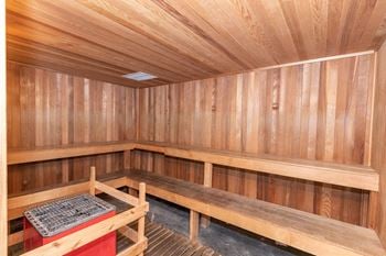 A wooden sauna with benches and a table