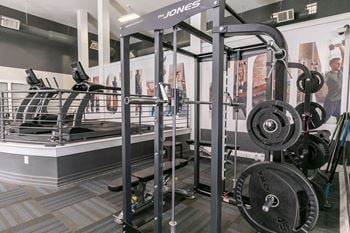 A gym with weights and cardio equipment in a building