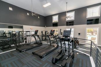 A gym with cardio equipment at the monarch apartments in midtown