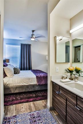 Las Vegas apartment for rent - a bedroom with a bed and a sink and a mirror