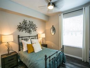 Las Vegas apartment for rent - a bedroom with a bed and a ceiling fan