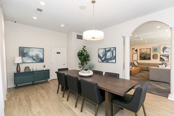 A dining room with a wooden table and chairs.