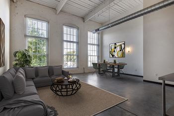 A living room with a gray couch and a table