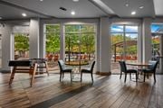 Dallas apartment for rent - a clubhouse with tables and chairs and large windows at South Side Flats, Dallas, 75215