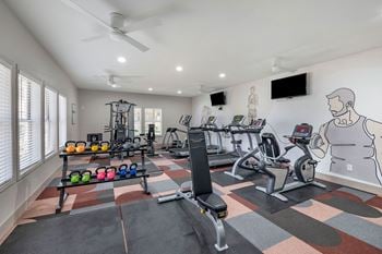  Home gym with exercise equipment and a wall mural of a man on the wall