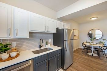  Kitchen with white cabinets and a stainless steel refrigerator