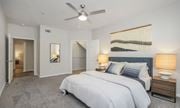 Pearland apartment for rent - a bedroom with a large bed and a ceiling fan at Sladestone Shadow Creek, Pearland, TX