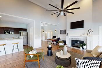 A clubhouse with a fireplace and a ceiling fan