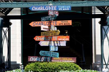 A sign with many different signs in front of a building