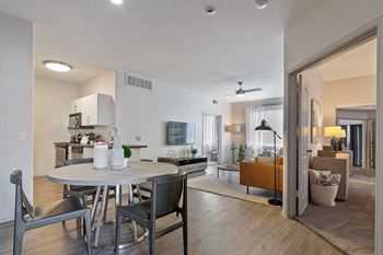 A view of the dining room and living room from the kitchen