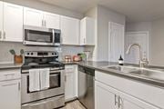 Phoenix apartment for rent - a kitchen with stainless steel appliances and white cabinets at Element Deer Valley, Arizona