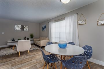 Pembroke Pines apartment for rent - A dining room with a white table and blue chairs.