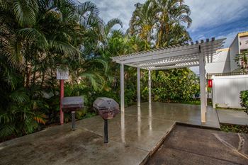  Backyard has a grill and a white canopy
