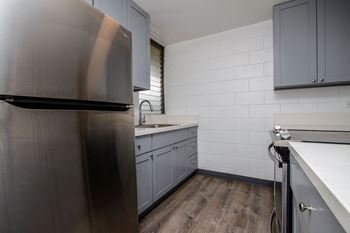 Kitchen with stainless steel appliances and white counter tops