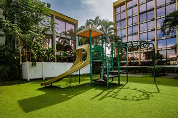 Playground with a slide next to a building