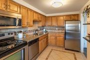 Las Vegas apartment for rent - a kitchen with stainless steel appliances and wooden cabinets at The Rays at Vegas Towers Apartments, Nevada