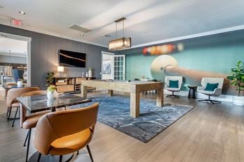 A living room with a dining room table and chairs