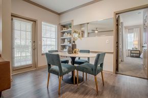 Houston apartment for rent - a dining room with a table and chairs in front of a window at Reserve by the Lake, Texas